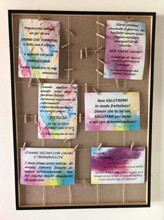 a bulletin board with notes pinned to clothes pins