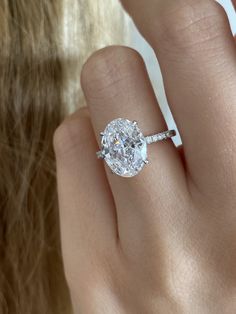 a woman's hand with a diamond ring on it