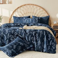 a bed with blue comforters and pillows in a room