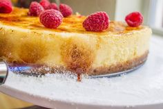 a piece of cheesecake with raspberries on top