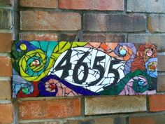 a brick wall with a painted sign on it that says, forty five and flowers