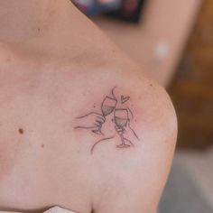 a woman with a wine glass tattoo on her shoulder