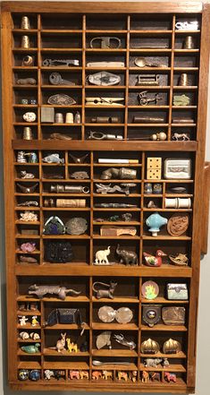 a wooden book shelf filled with lots of different items