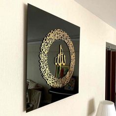 a mirror hanging on the side of a wall next to a table with a lamp