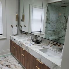 a bathroom with marble counter tops and double sinks