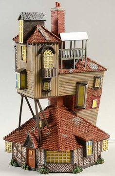 a toy house made out of cardboard with windows and balconies on the roof