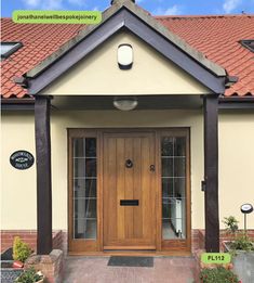 the front entrance to a house with two doors