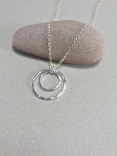 Item Description: This minimalist hammered recycled sterling silver double circle pendant is comprised of two hammered silver circles with a high polish. I love the way the light catches the hammered detail. Both circles are independent and move which adds interest. This would make a wonderful gift for anyone who loves craft jewellery or silver, or indeed a little treat for yourself!  Item Dimensions: Outer pendant diameter - c. 24-25 mm (1 inch) Supplied on a belcher chain. All my jewellery comes in a beautifully branded box - just right for gifting. FREE UK postage: My standard FREE UK delivery is provided by Royal Mail Signed For services - upgrades are available. For non-UK postage I use Royal Mail international tracked/signed.  All of the jewellery I sell is handmade by myself using h Gifts For A Girlfriend, Personalised Christmas Gifts, Double Circle Necklace, Last Minute Gift Ideas, Sterling Silver Jewelry Rings, Thoughtful Gift Ideas, Personalised Jewellery, Silver Jewelry Design, Hammered Sterling Silver