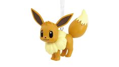 a pokemon ornament hanging from a white cord with a yellow and brown animal on it