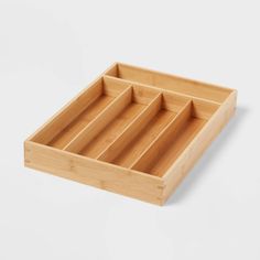 a wooden tray with six compartments on it