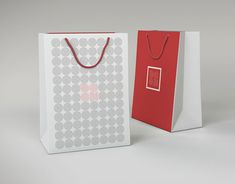 two white and red shopping bags on a grey background with the same bag as it appears