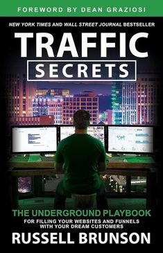 a man sitting at a desk in front of two monitors with the words traffic secrets on it