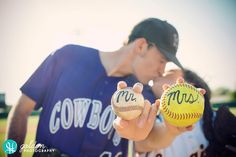 a couple of people that are holding some baseballs