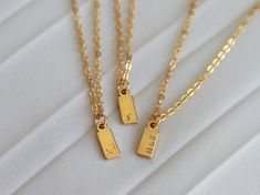 Personalize your necklace and create a meaningful gift with our Initial Tag Necklace. Ideal for everyday wear and layering, this stunning necklace is the perfect gift for yourself, loved ones, bridesmaids, or weddings. Each item is meticulously hand-stamped and personalized, offering a variety of meanings and love. Crafted with tarnish-resistant stainless steel, our materials ensure long-lasting beauty. Customize the charm with one to three characters (letters or numbers) to make it uniquely yours. The necklace hangs elegantly from a 16-inch chain with a 2-inch extender. It comes ready to be gifted on a jewelry card. Materials: - Hypoallergenic stainless steel chain  - Stamped stainless steel tag - Chain length: 16 inch + 2  inch extender Personalization:  You have the option to personaliz Minimalist Pendant Charm Necklace For Best Friend, Minimalist Initial Pendant Charm Necklace For Gift, Minimalist Initial Pendant Charm Necklace As Gift, Simple Initial Pendant Charm Necklace For Gift, Minimalist Charm Necklaces As Mother's Day Gift, Minimalist Charm Necklaces As A Mother's Day Gift, Minimalist Silver Charm Necklaces For Mother's Day Gift, Minimalist Charm Pendant Necklace Gift, Minimalist Pendant Charm Necklaces As Gift