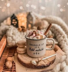 a mug filled with marshmallows sitting on top of a table