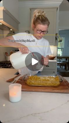 a woman pours milk into a casserole dish on a wooden cutting board