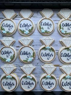 twelve decorated cookies with the names of each member in order to match their wedding rings