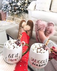 two mugs filled with hot chocolate and marshmallows