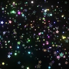 many different colored stars on a black background