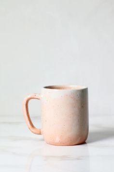 a coffee cup sitting on top of a white counter