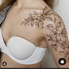 a woman's shoulder with flowers on it