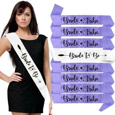 a woman in a black dress is holding a purple sash with the words bride and tribe on it