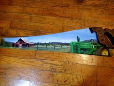 a pair of pliers sitting on top of a wooden floor next to a farm scene