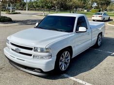 a white truck parked in a parking lot