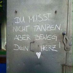 graffiti written on the side of a metal door with writing in white ink that reads, du must night tanen, aber beweg dei here