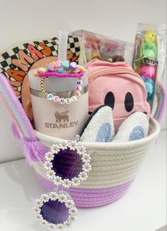 a basket filled with lots of items on top of a white table next to a purse