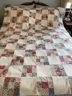 a bed with a quilt on top of it