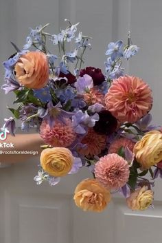 a person holding a bouquet of flowers in their hand