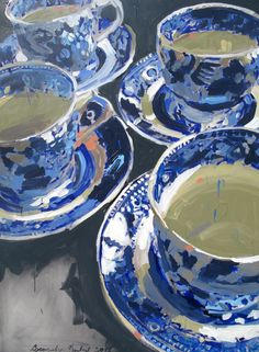 several blue and white plates with saucers on top of each other, one is filled with green liquid