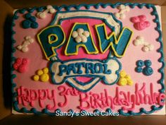 a pink and blue birthday cake with the words paw patrol written in white frosting