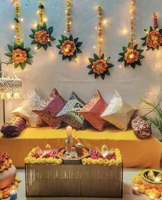 a decorated stage with flowers, candles and decorative items on it's sides for diwaling