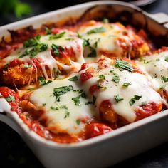 a casserole dish with meat, cheese and sauce in it on a table