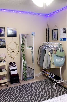 a room with clothes hanging on racks, shoes and other items in the closet next to it