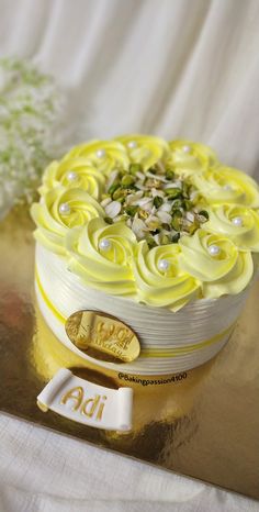 a yellow and white cake with flowers on it