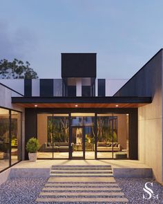 an entrance to a modern house with steps leading up to it