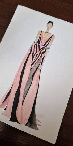 a drawing of a woman's dress on a piece of paper that is laying on a table