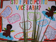 a bulletin board with writing on it and grass in the foreground, surrounded by clouds