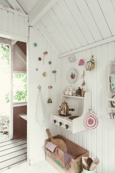 a room with white walls and lots of things on the wall, including a shelf