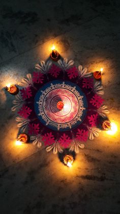 an overhead view of a decorated plate with lit candles