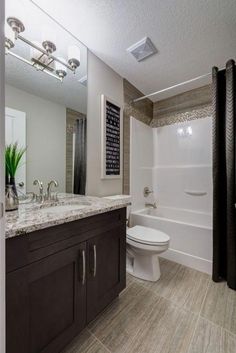 a bathroom with a sink, toilet and bathtub