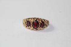 SKU: 0238 A beautiful garnet fancy ring set in 9ct yellow gold. This pretty ring would be perfect for any and every occasion. Size: UK: P American: 7 1/2 Continental: 16 This is a vintage item and such has wear. There may be some superficial scratches, otherwise the item is good condition. This item comes beautifully boxed in our own packaging. Processing time for orders is 1-3 business days. Pretty Ring, Fancy Rings, Pretty Rings, Rings Statement, Ring Set, Class Ring, Ring Sets, Garnet, Statement Rings