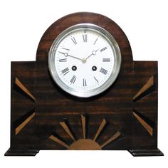 a wooden clock with roman numerals on the face and hands, in an art deco style