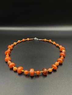 A beautiful collection of very old ancient Carnelian Beads Himalayan beads The origin of this beads are from Tibet . very unique shape of the carnelian some brass beads are used as spacers the age of this beads are more than 1000 years old we provide fast and free shipping service world wide Amber Beaded Necklace With Large Beads As Gift, Artisan Orange Beads, Gems, And Cabochons For Gifts, Amber Beaded Necklaces With Large Beads For Gifts, Amber Agate Beaded Necklace With Colorful Beads, Handmade Amber Carnelian Beaded Necklaces, Amber Agate Jewelry With Colorful Beads, Carnelian Jewelry With Colorful Round Beads, Carnelian Jewelry With Colorful Beads, Amber Natural Stones Beads For Jewelry Making