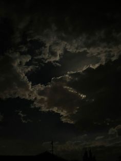 the sky is dark and cloudy at night with some clouds in it's foreground