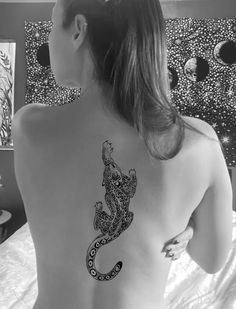 a woman with a tattoo on her back