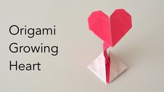 an origami heart on top of a piece of paper with the words organic growing heart above it